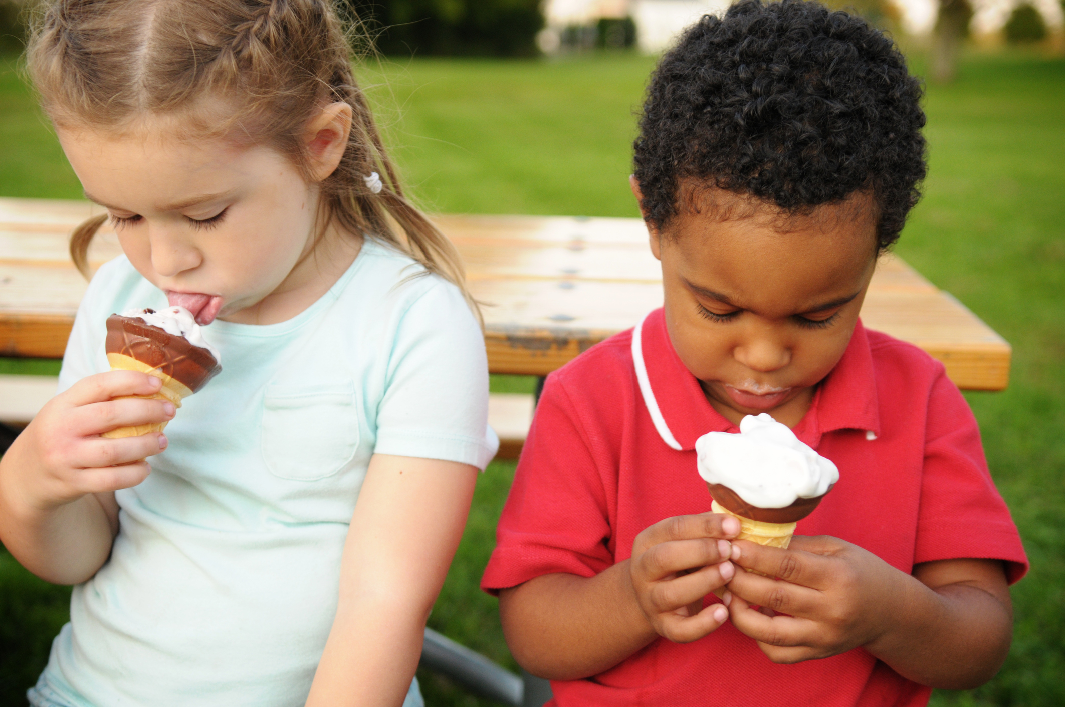 Little Boy and Girl Eating Ice Cream Cones Outside
