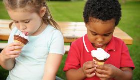 Little Boy and Girl Eating Ice Cream Cones Outside