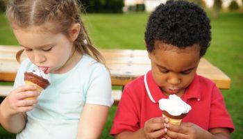 Little Boy and Girl Eating Ice Cream Cones Outside