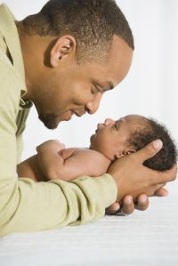 African father looking at newborn baby