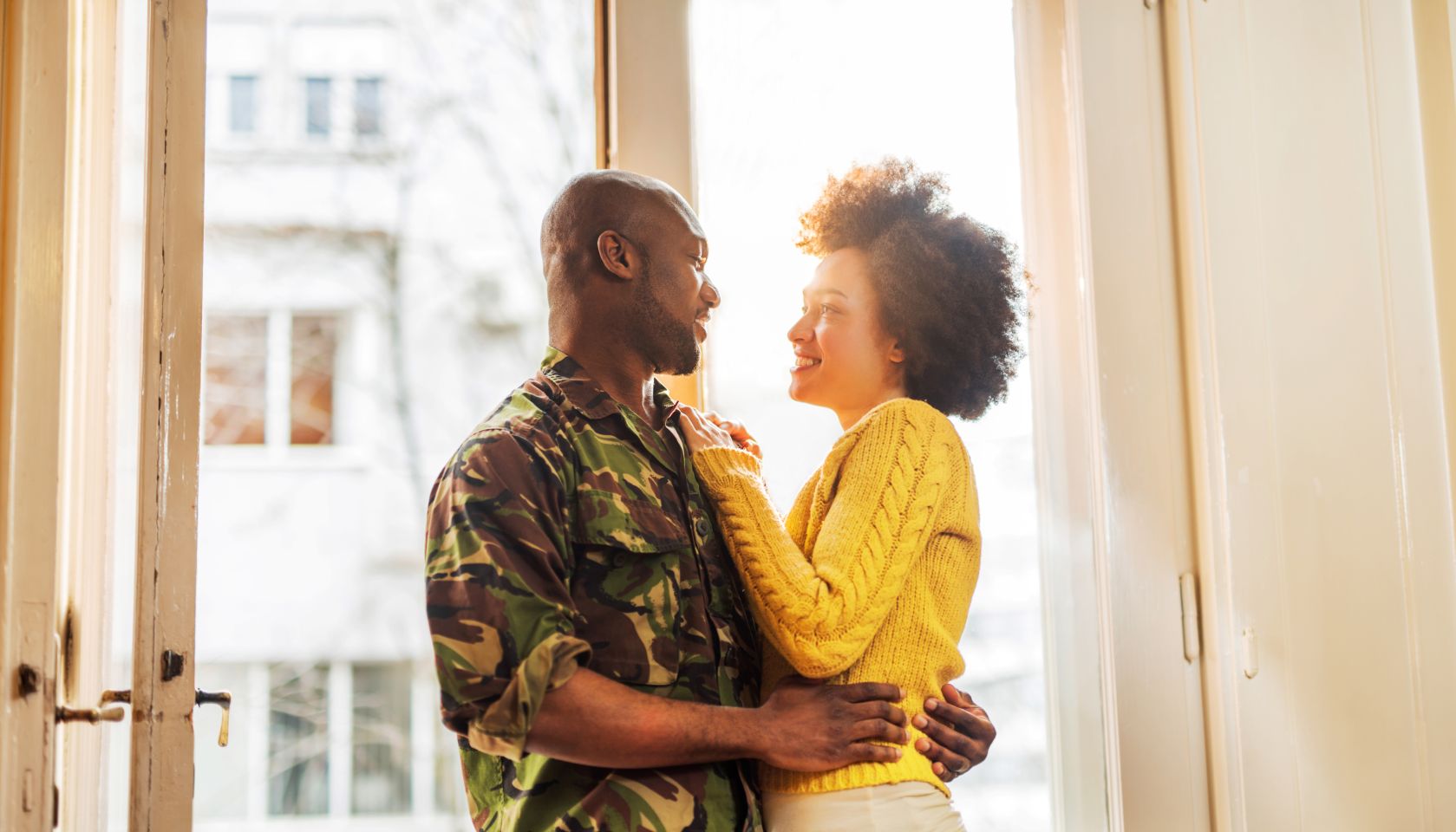 Happy African American soldier coming home to his wife.