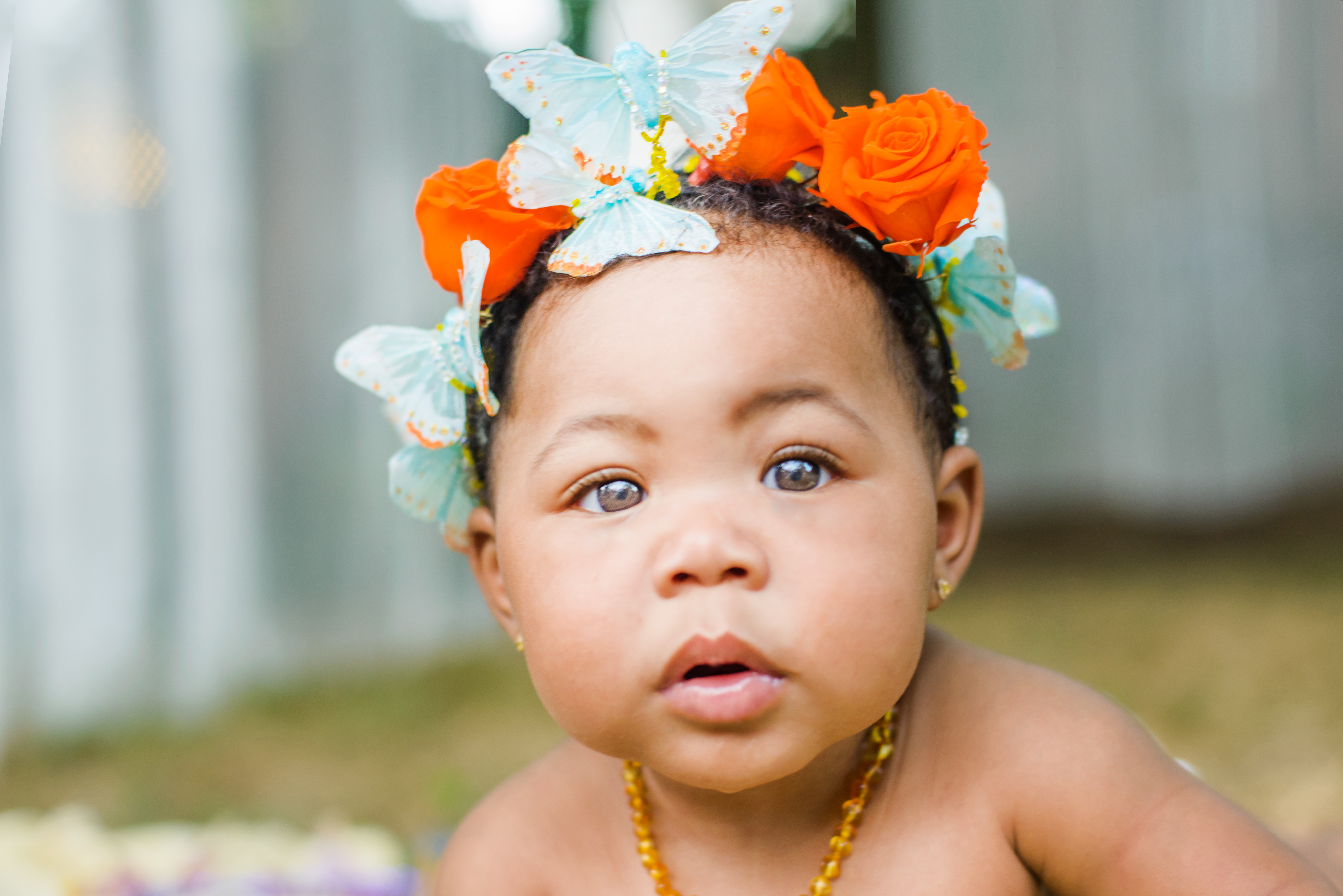Portrait of baby girl wearing butterflies and flowers in her hair