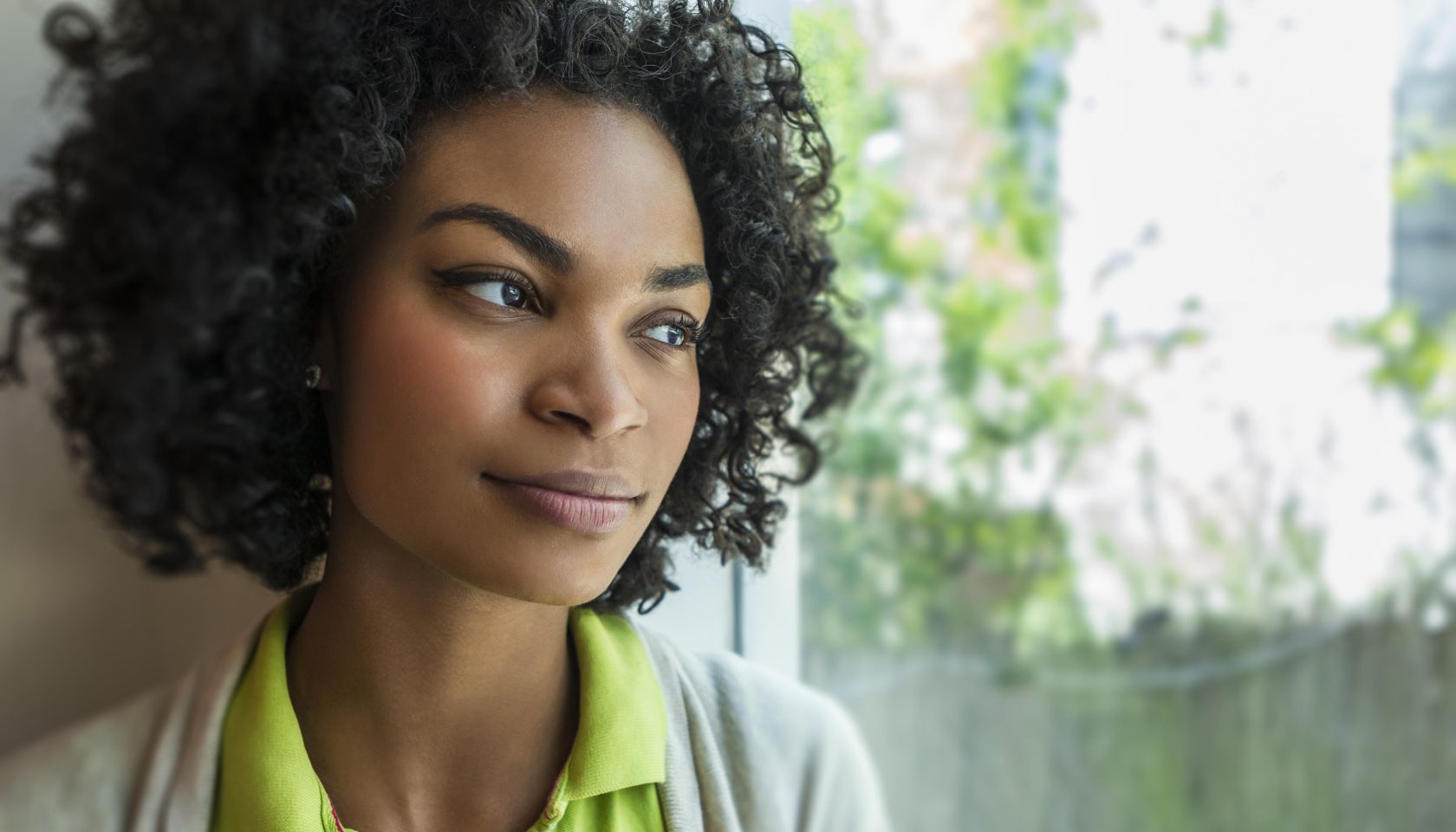 Woman looking thoughtfully out the window