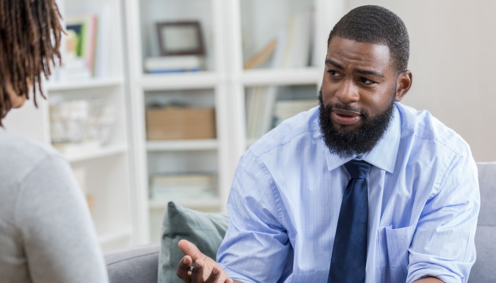 Mental health professional talks with female patient