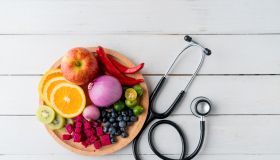 Healthy food in heart dish with doctor's stethoscope