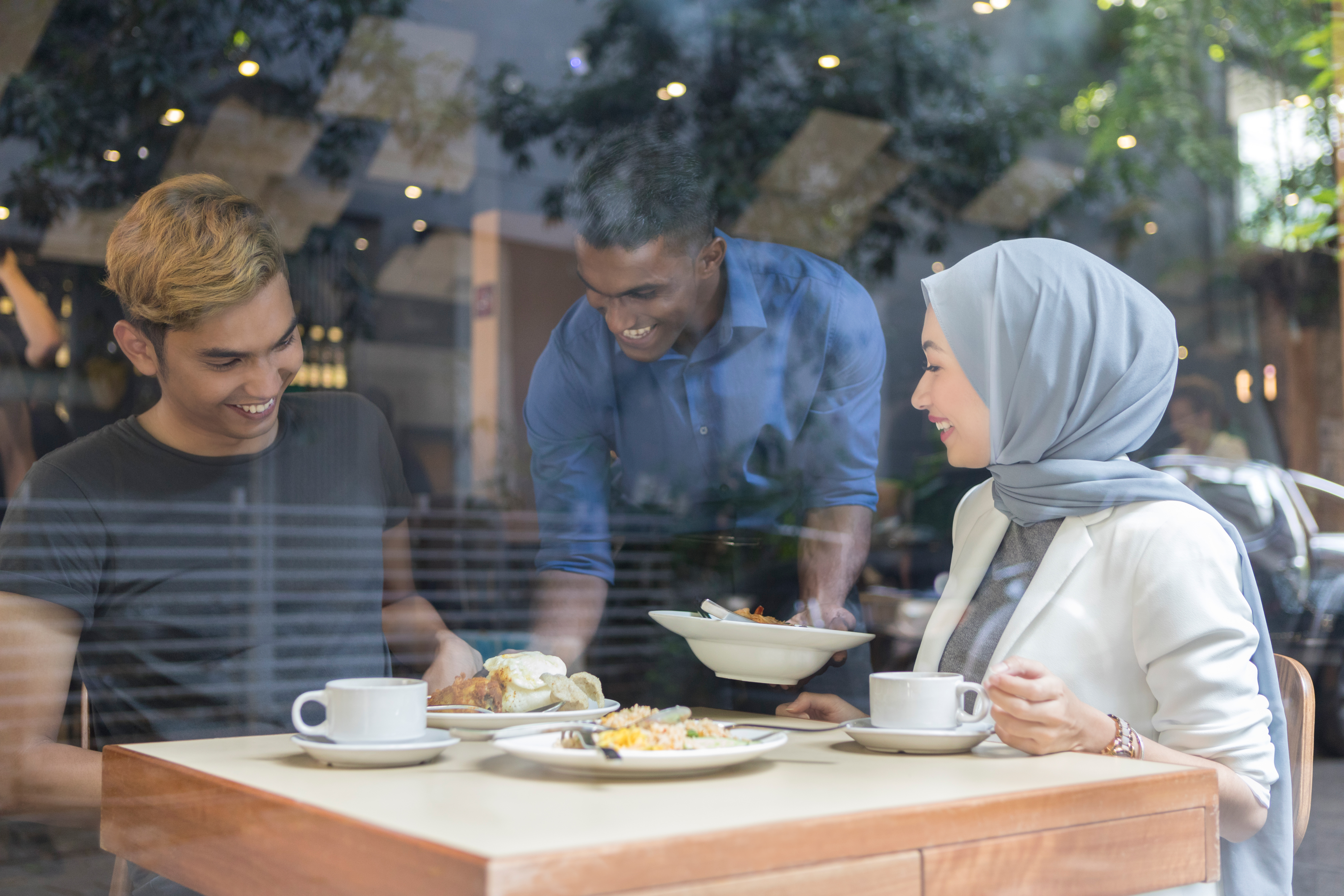 Young Malaysian couple enjoys restaurant breakfast