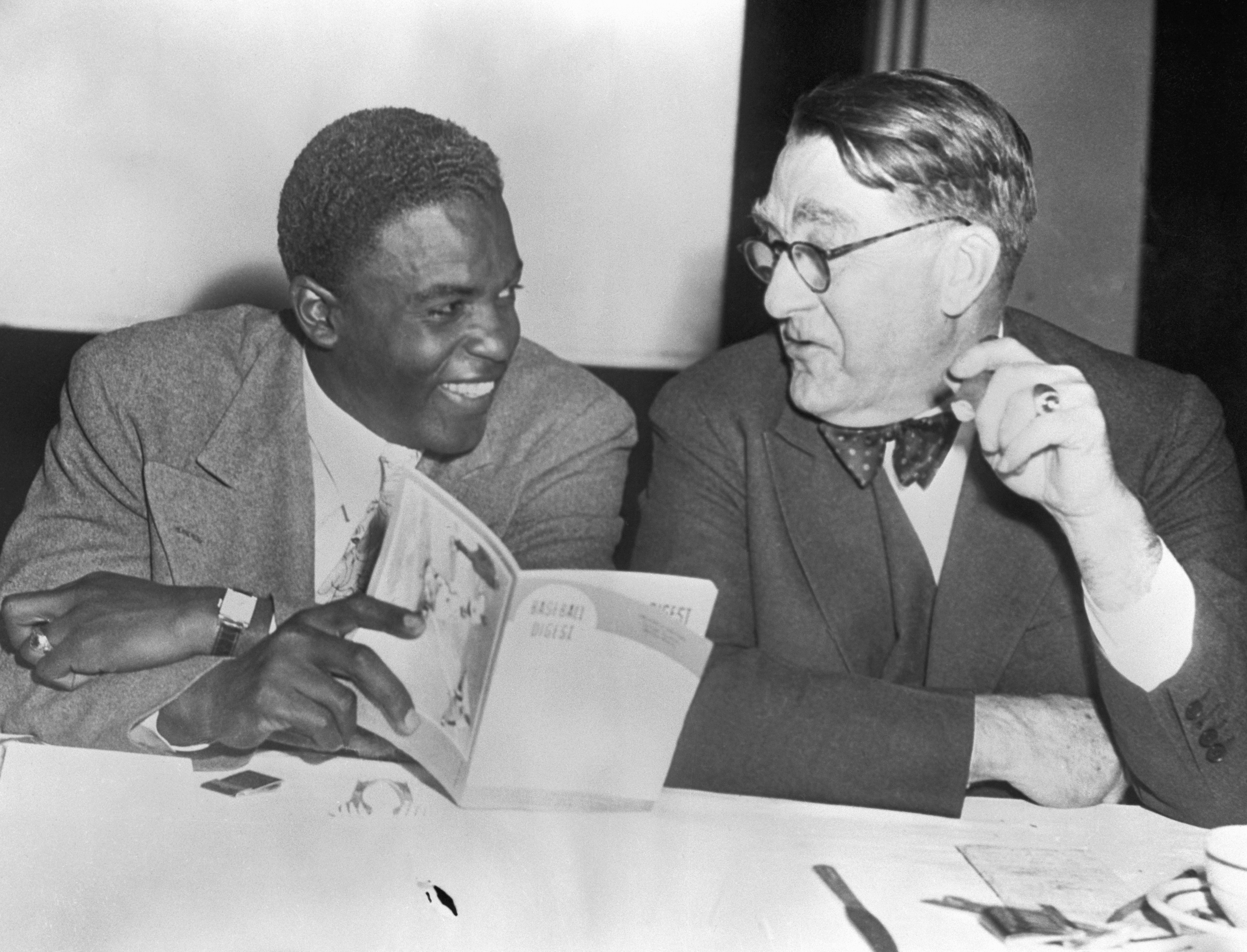 Jackie Robinson and Branch Rickey Looking at Book