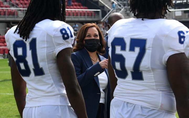 US Vice President Kamala Harris Applauds After Tossing The Coin