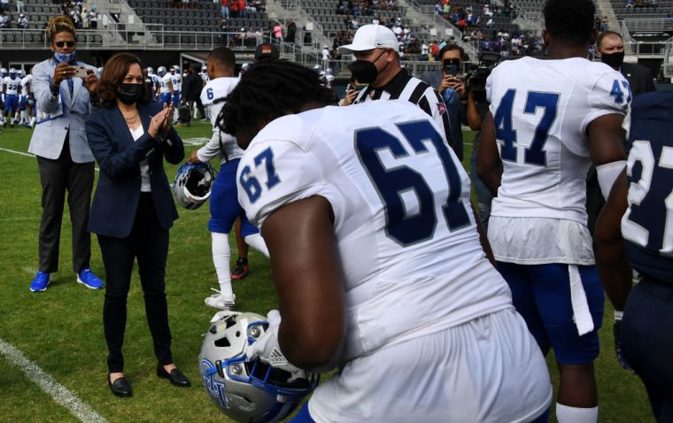 US Vice President Kamala Harris Applauds After Tossing The Coin