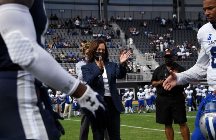 US Vice President Kamala Harris Applauds After Tossing The Coin