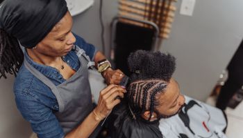 African American man having his hair braided