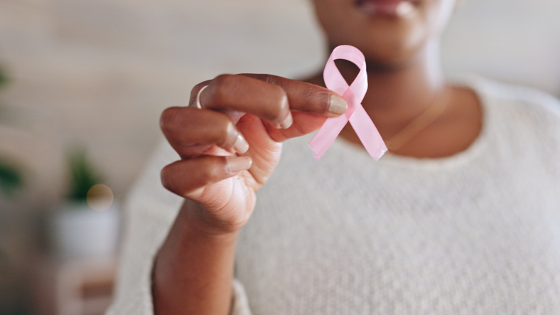Breast cancer, pink ribbon and hands of black woman with symbol for awareness, testing and health check. Healthcare, medical care and girl holding bow, sign and icon for disease prevention or support