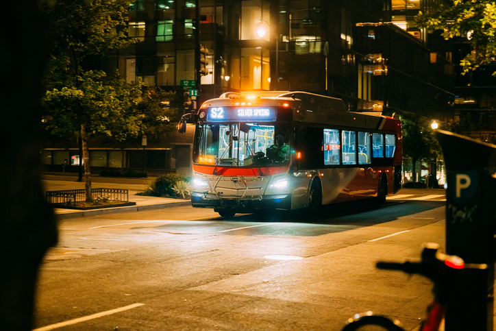 Public City Bus Passing in Washington D.C. at night